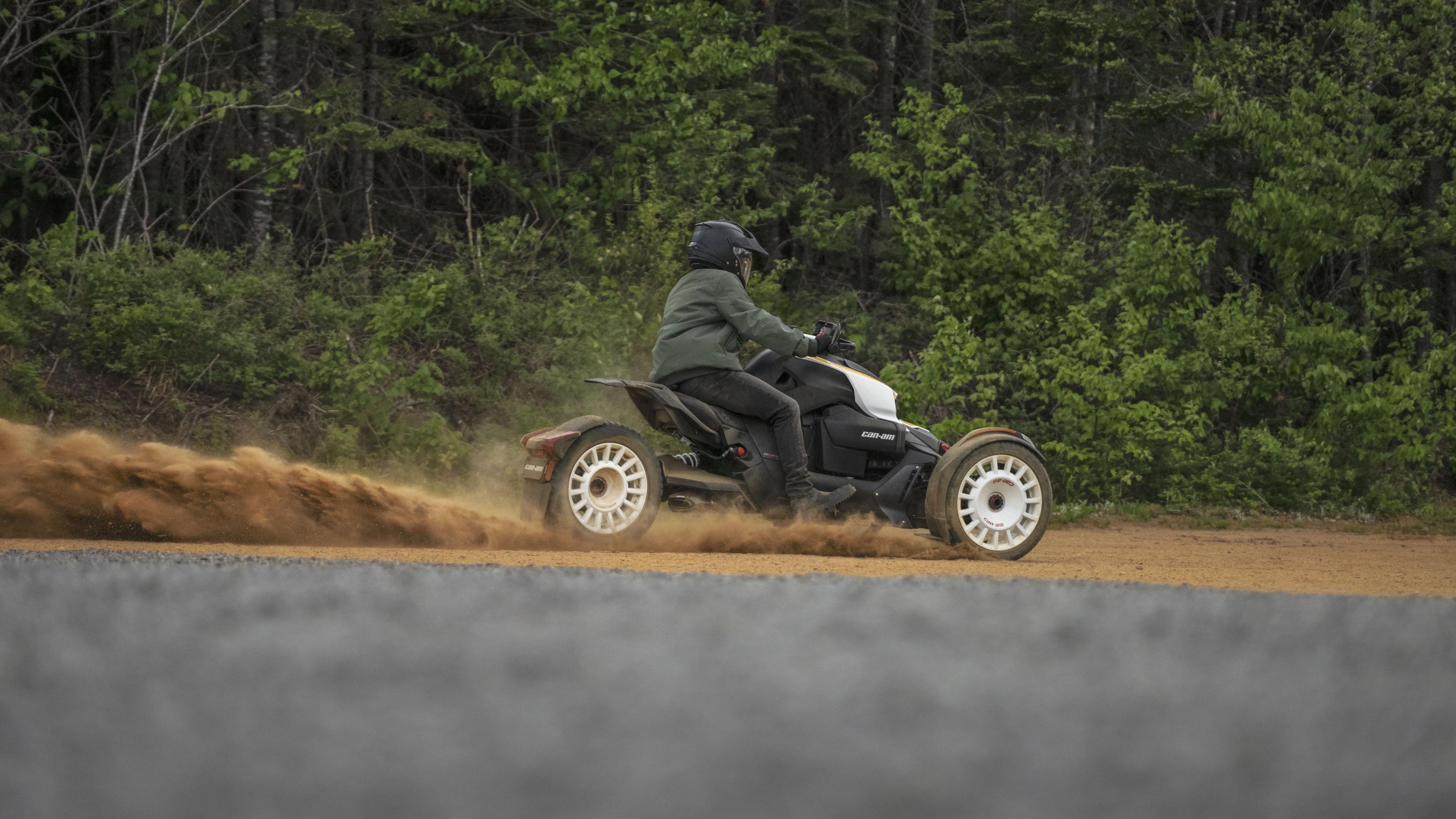 A man riding a Can-Am on a dirt road