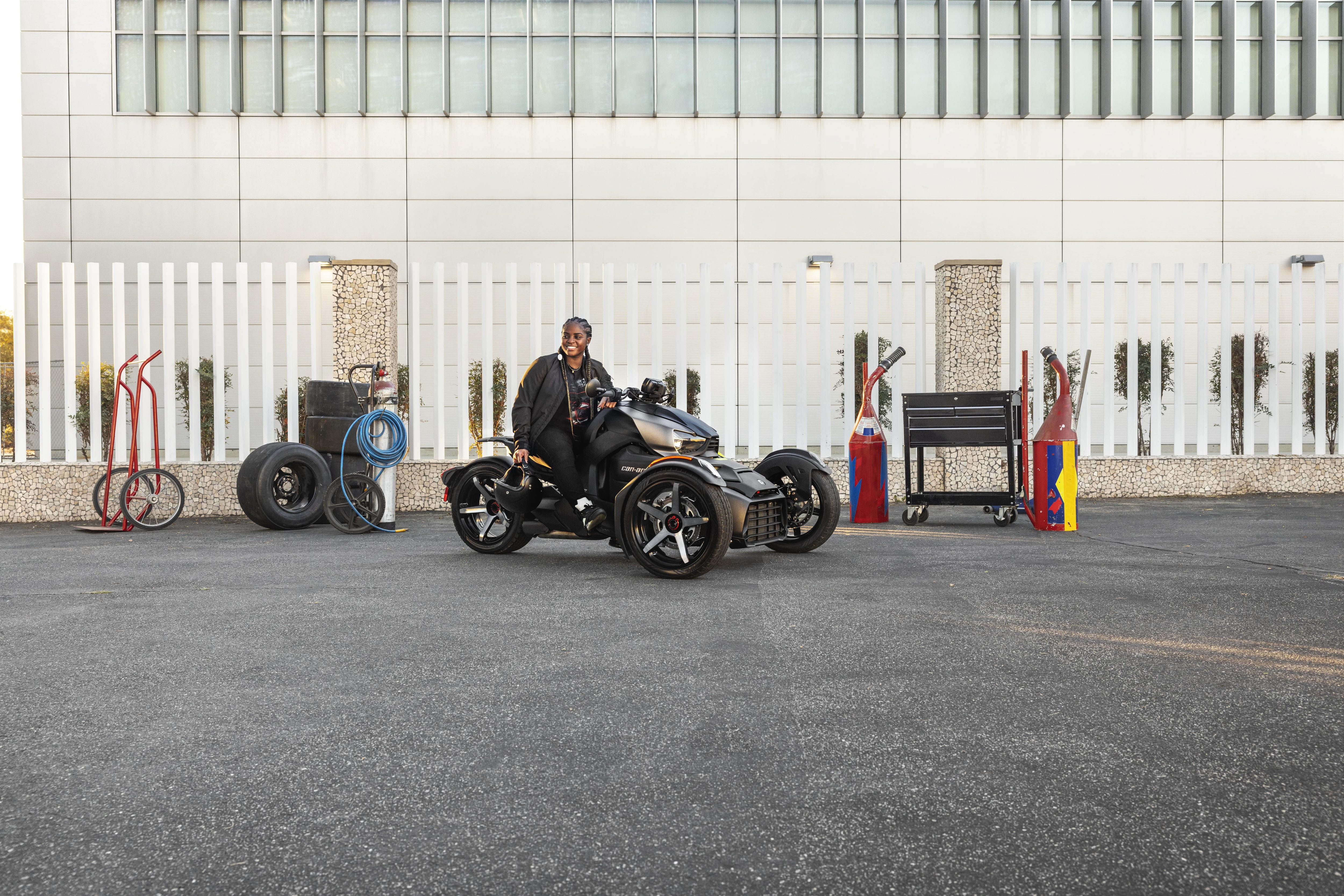 A woman proudly seated on her Can-Am Ryker Sport, designed for everyday driving.