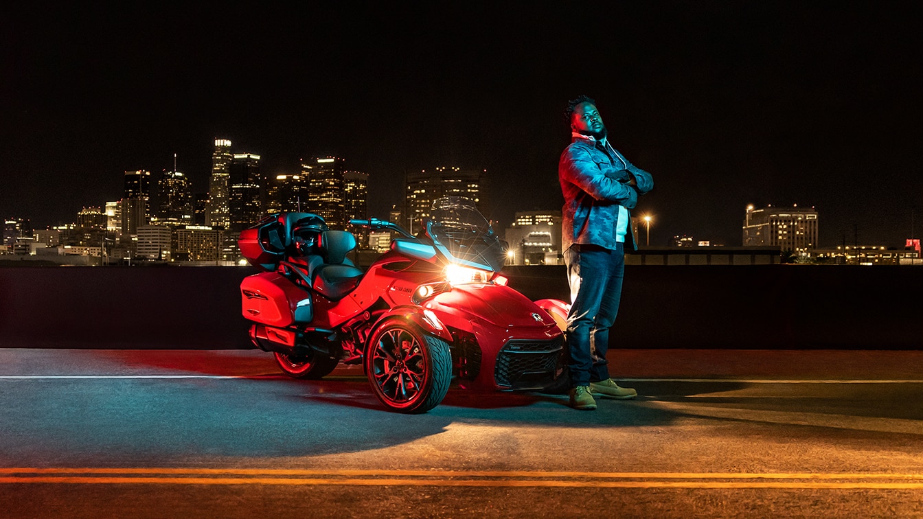 Man posing near his Can-Am Spyder F3 3-wheel motorcycle