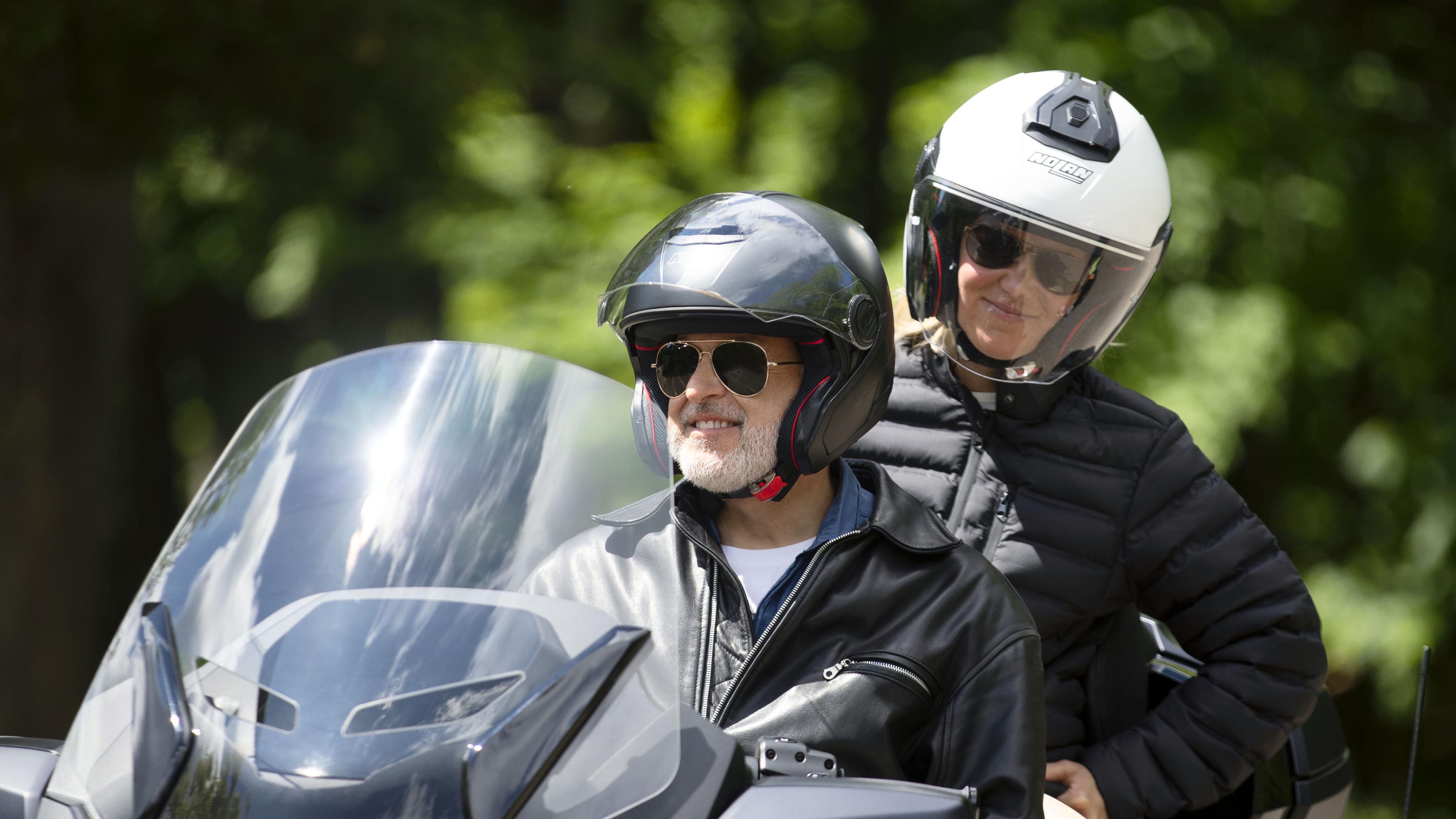 Man and woman geared with helmets on their Can-Am Rider