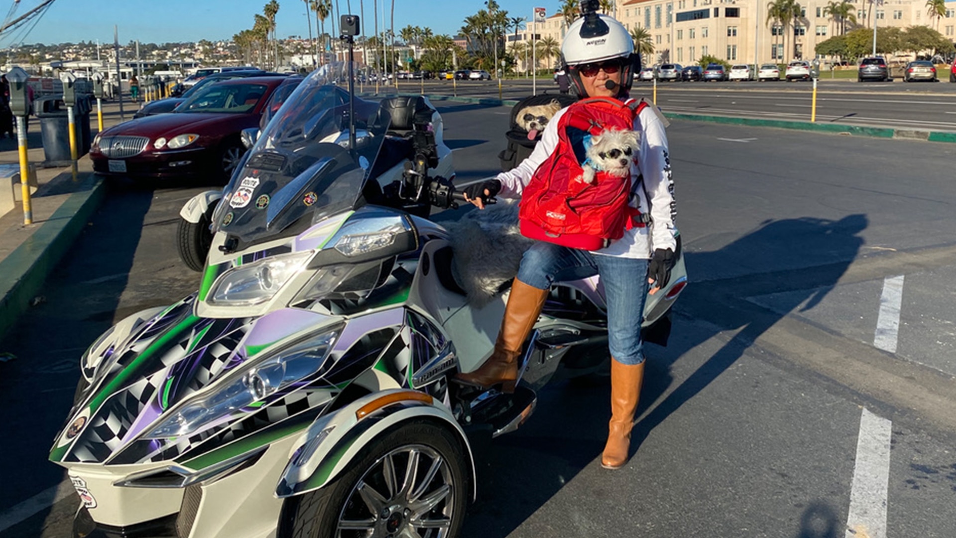 Can-Am On-Road ambassador Mihee Olsen next to her Spyder RT with her dogs