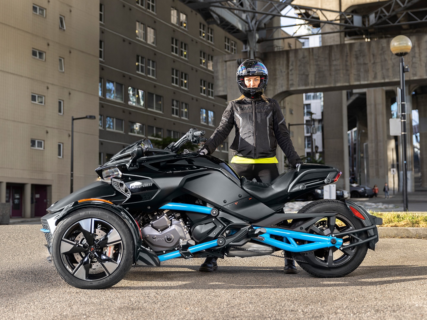 Woman posing with her Can-Am Spyder F3 Sport 3-wheel motorcycle