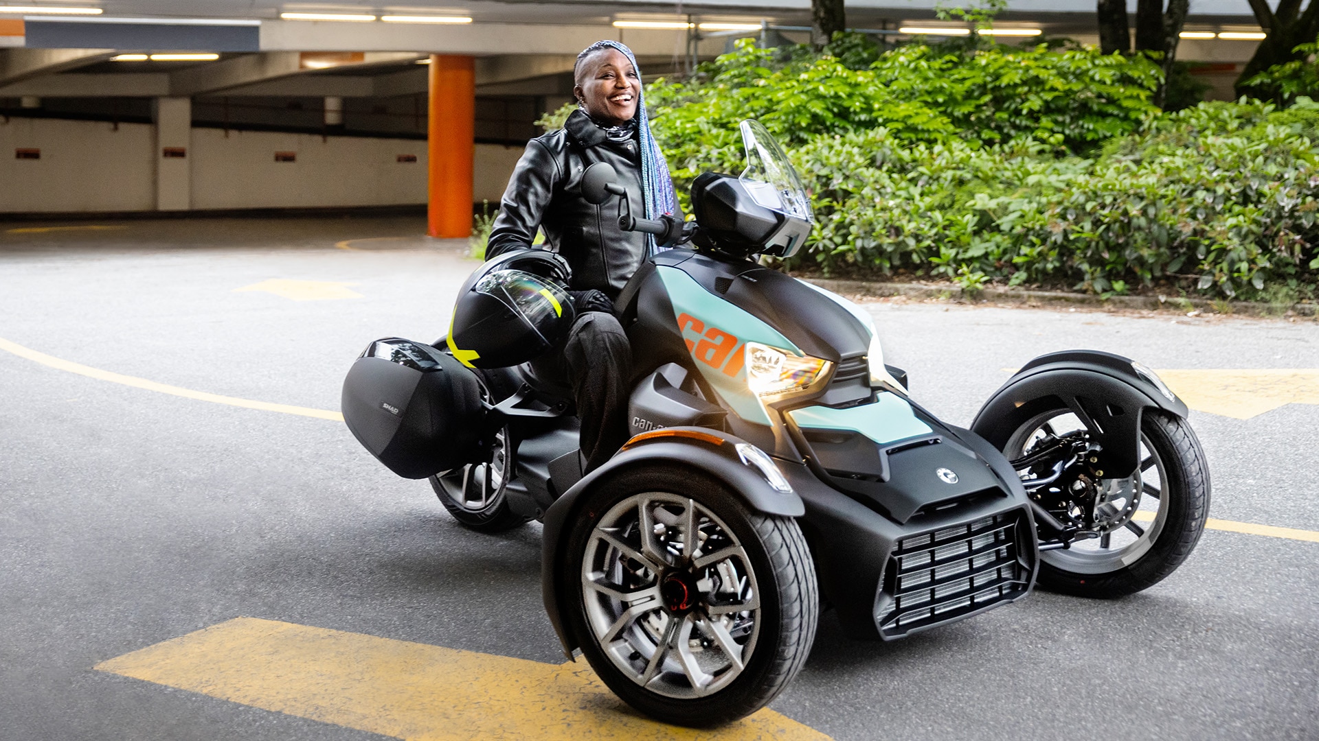 Woman sitting on a 2023 Can-Am Ryker with new Can-Am apparel