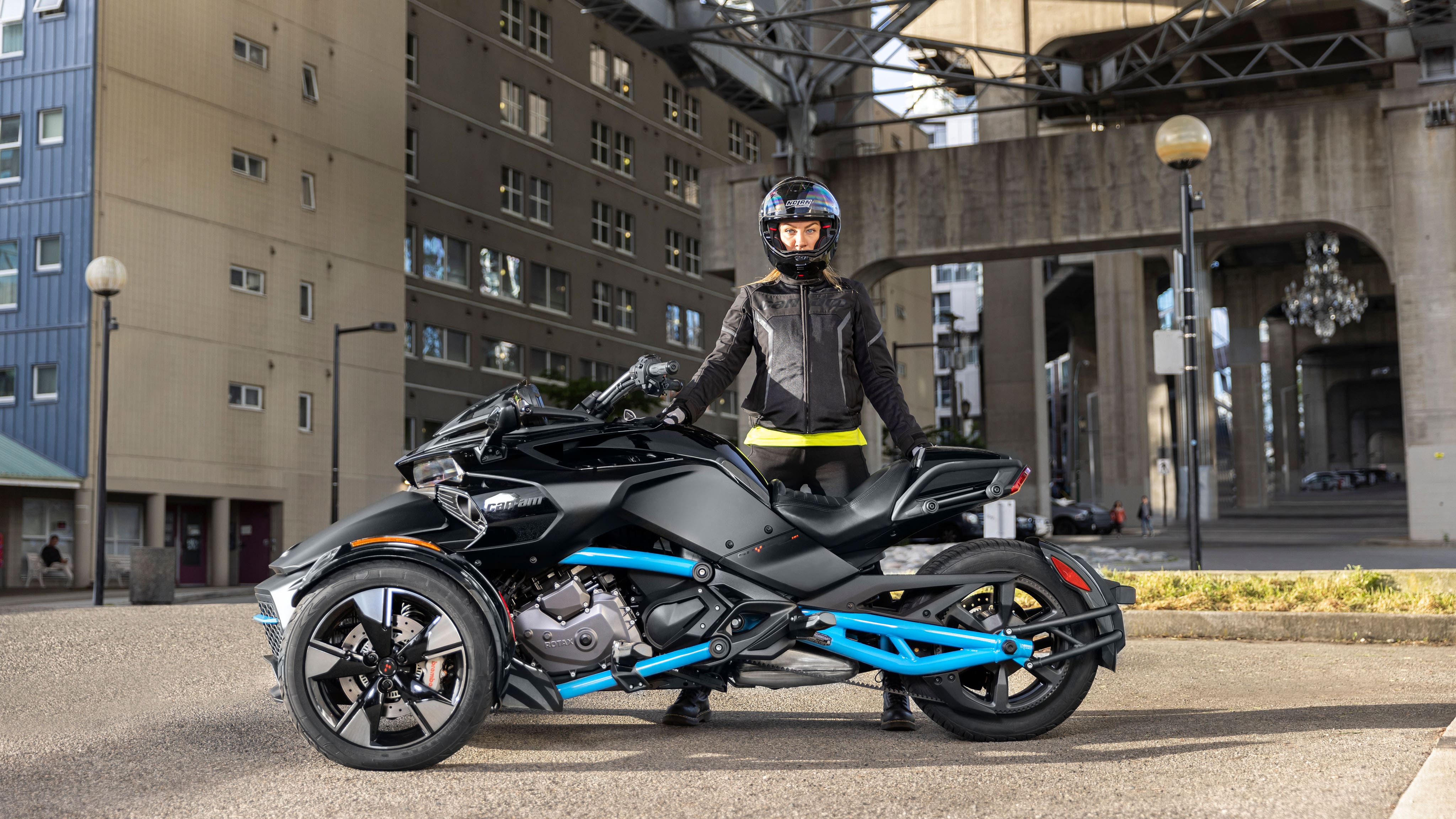 Rider standing next to a 2023 Can-Am Spyder F3 