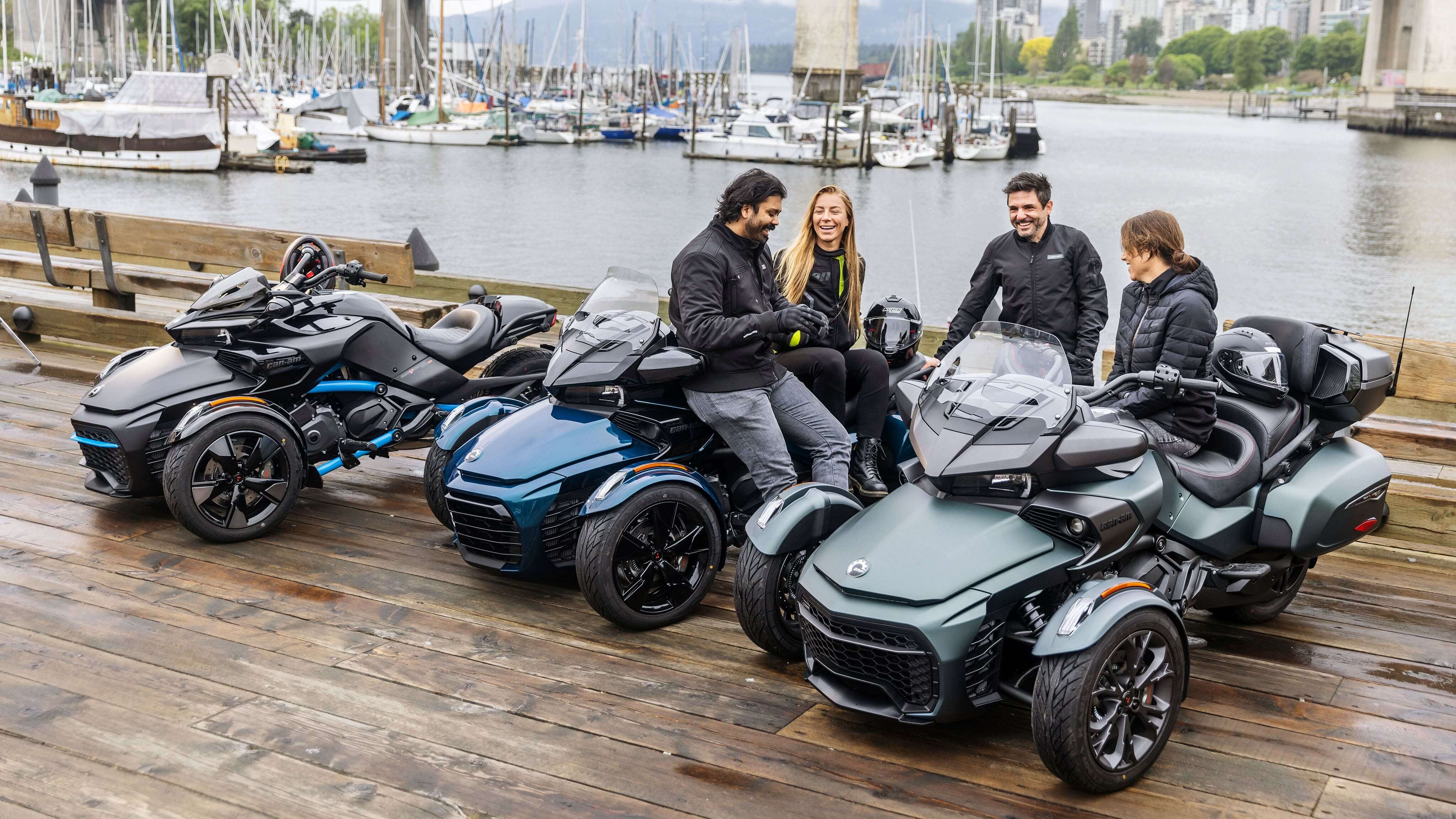 Riders talking and sitting on their Can-Am Spyder F3 vehicles next to a port