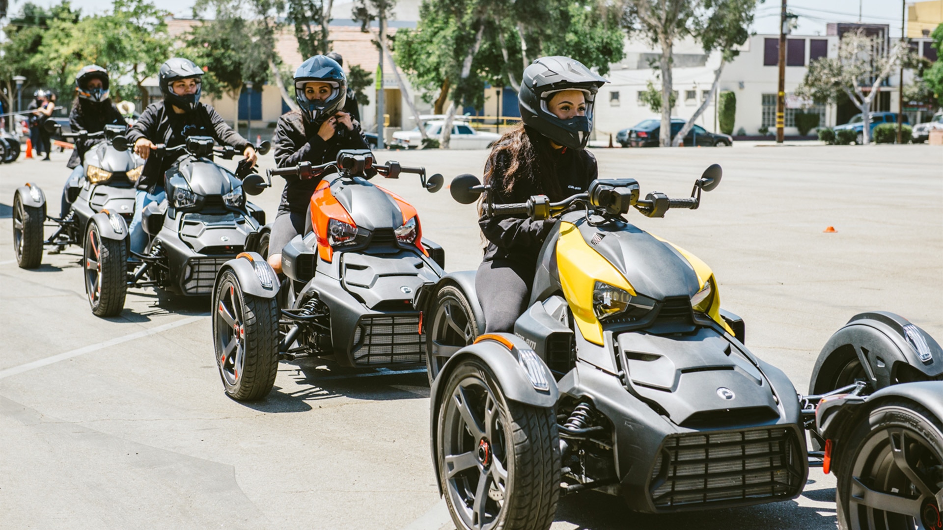 Multiple women taking a Rider Education Program course to learn to drive 3-wheel Can-Am vehicles