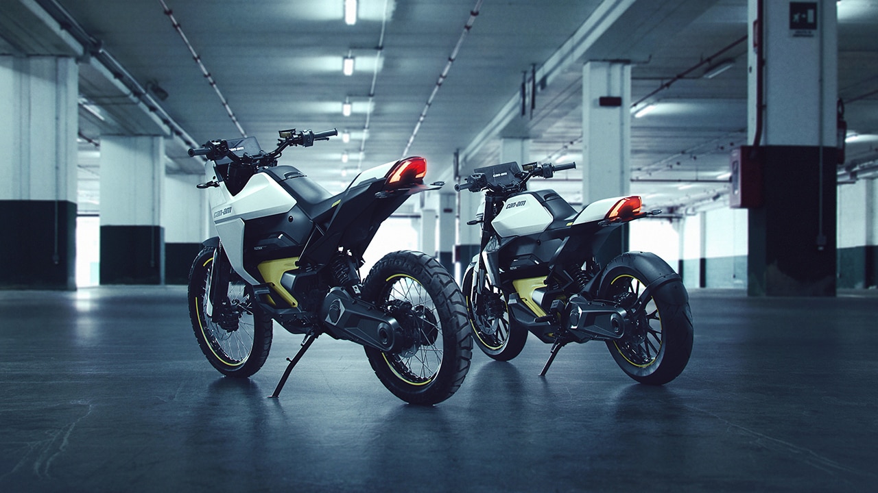 Two electric motorcycles with an industrial background