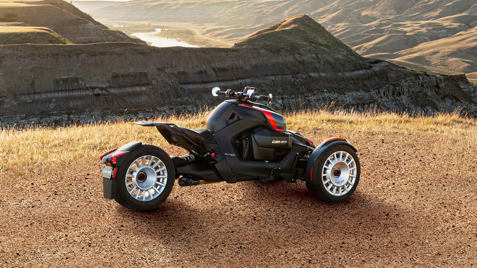 2024 Can-Am Ryker parked on a grassy field overlooking mountains