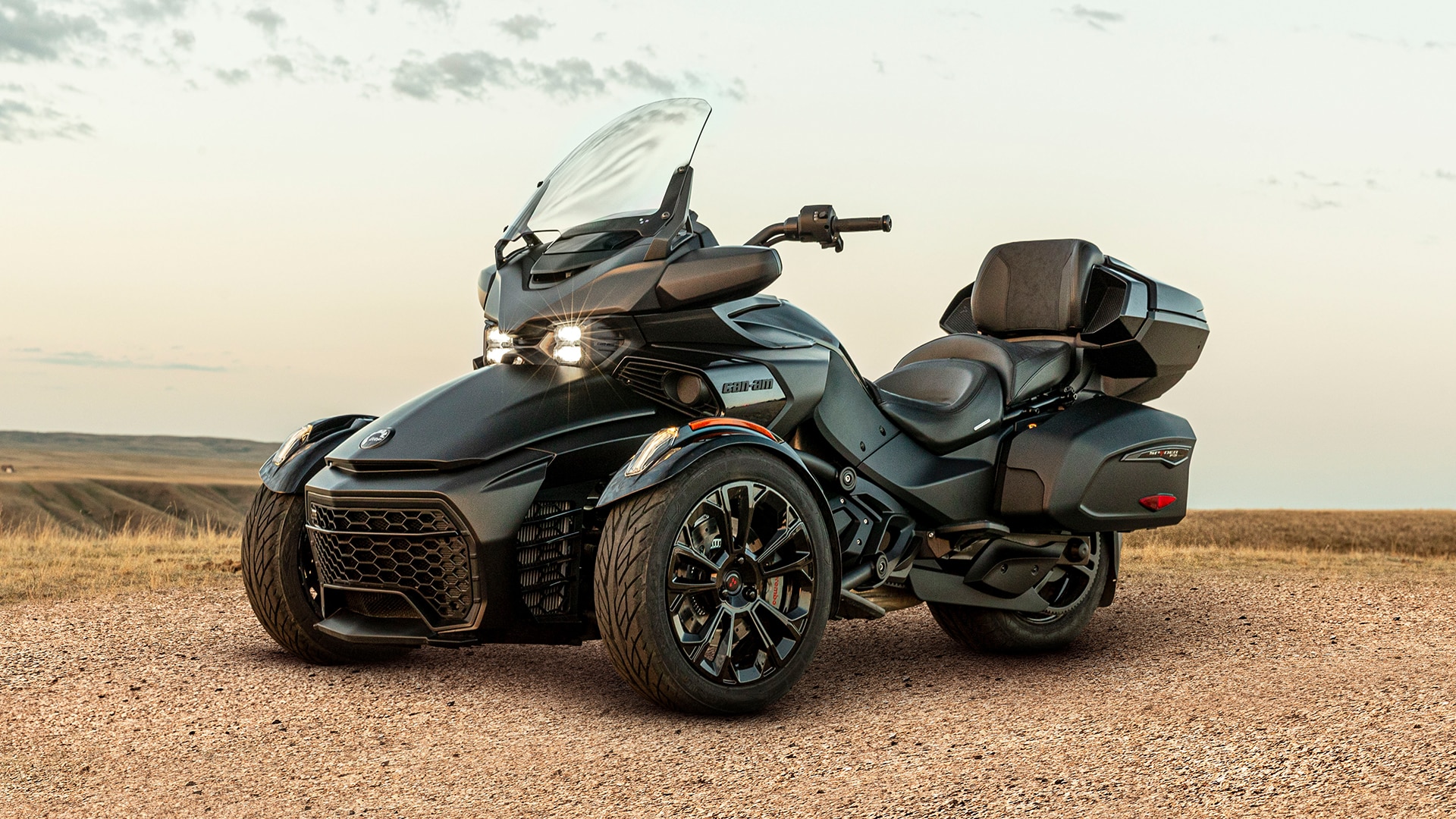 Sideshot of the new 2024 Can-Am Spyder F3 on a dirt road