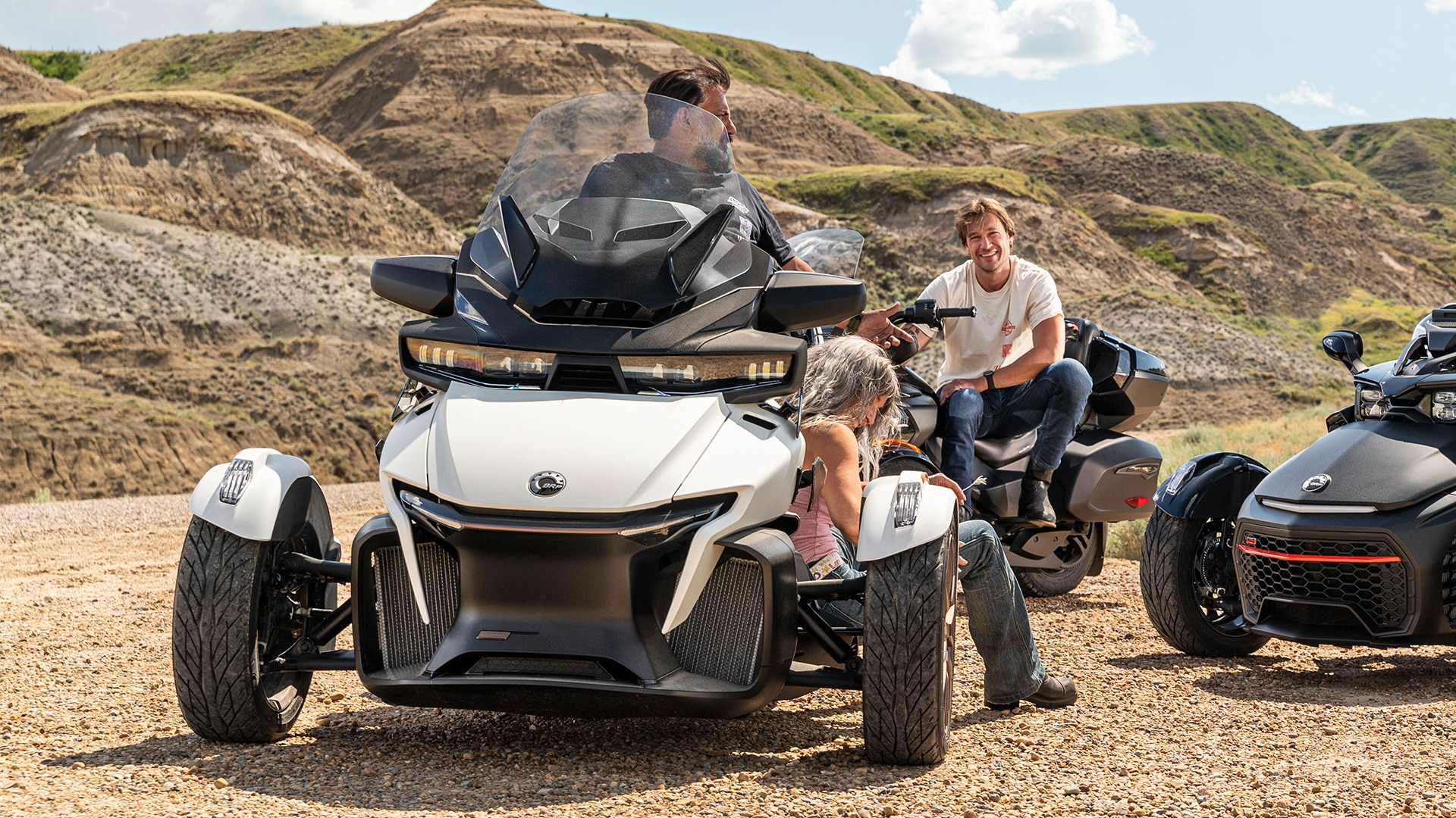 3 riders sitting on their Can-Am Spyder RT on a dirt road