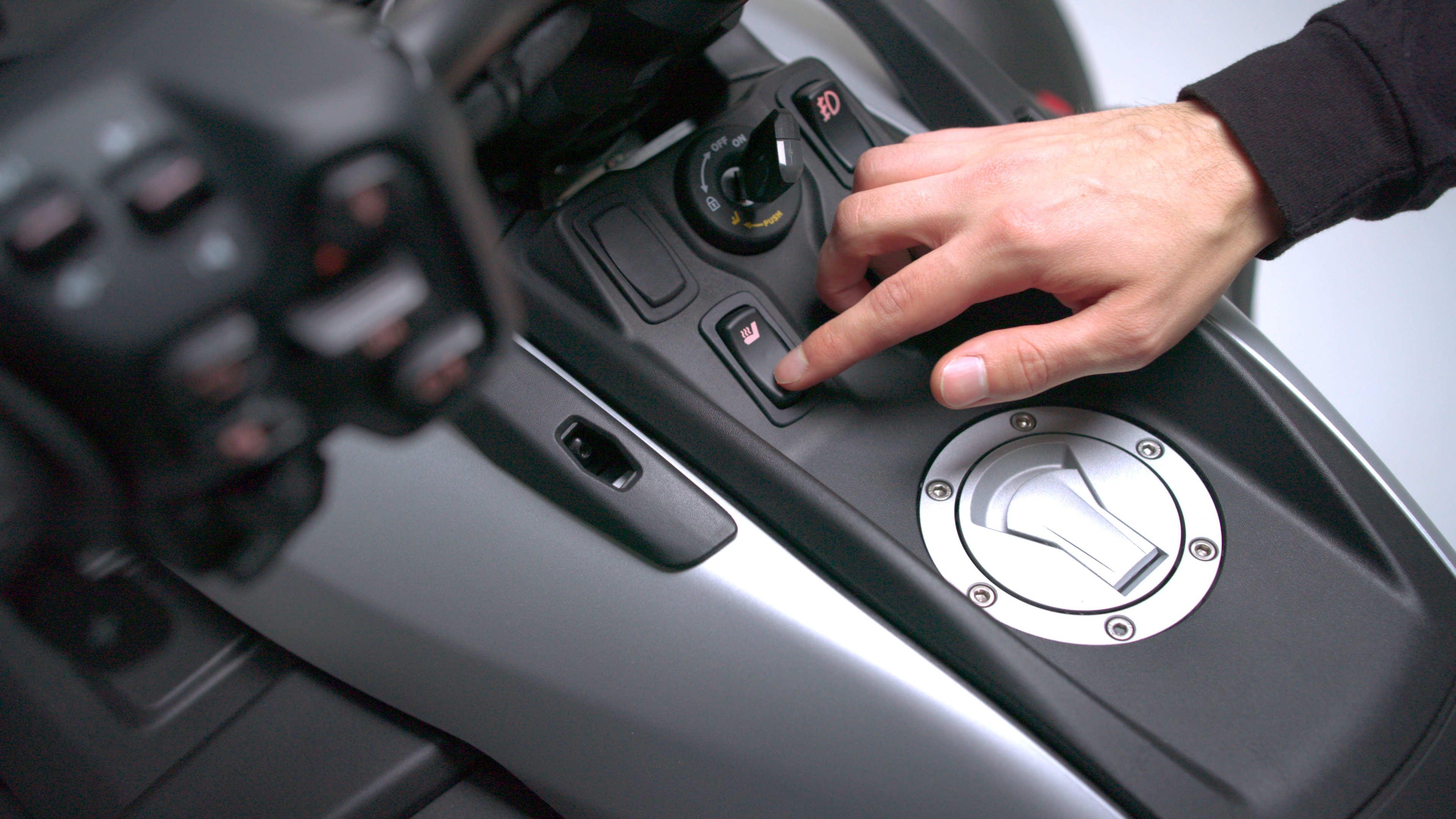 A driver checks his Can-Am 3-wheel vehicle