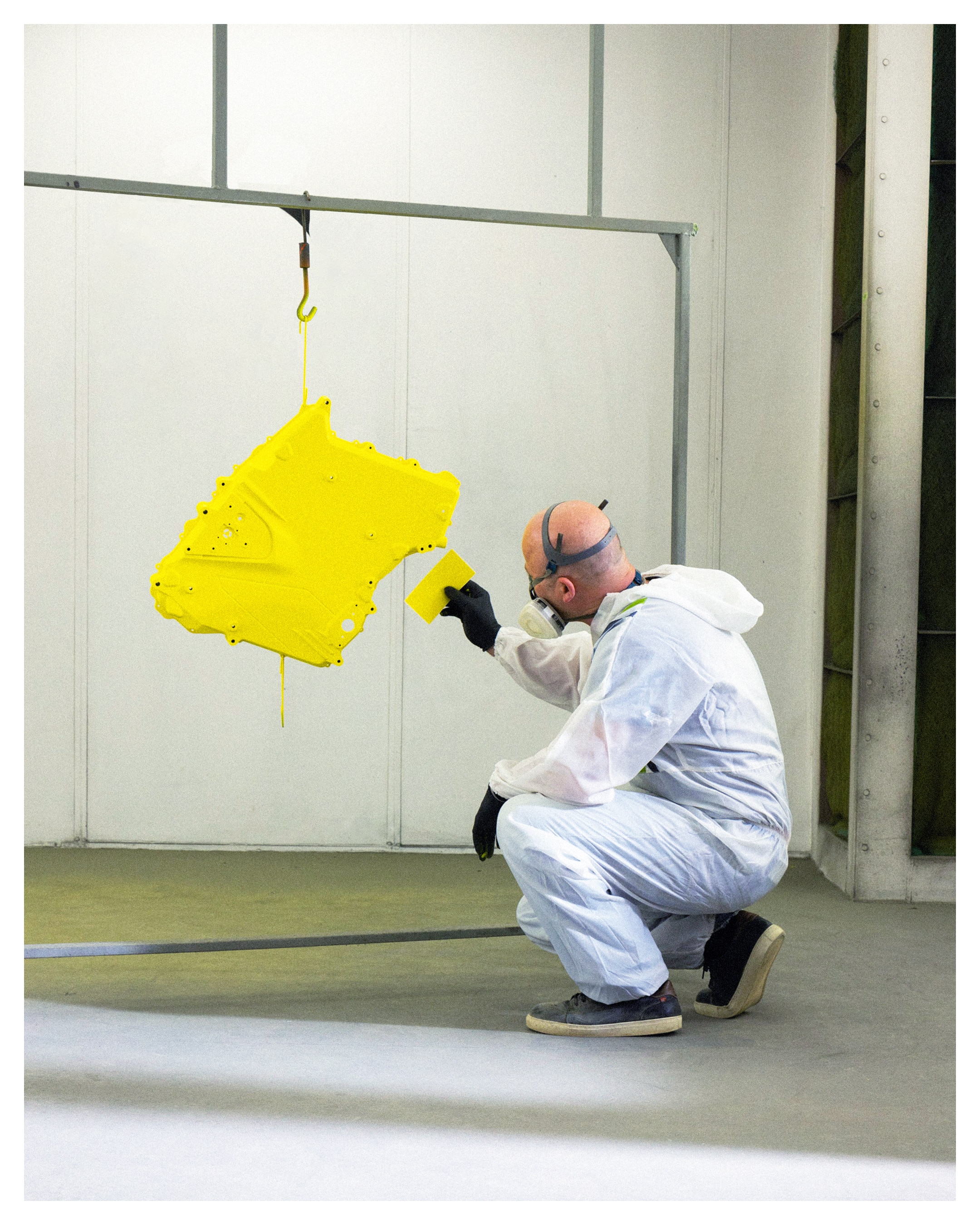 Engineer paint spraying pieces of a Can-Am motorcycle and comparing colors