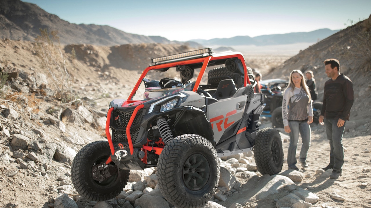 A Can-Am Maverick Sport X XC parked in a rocky setting. 