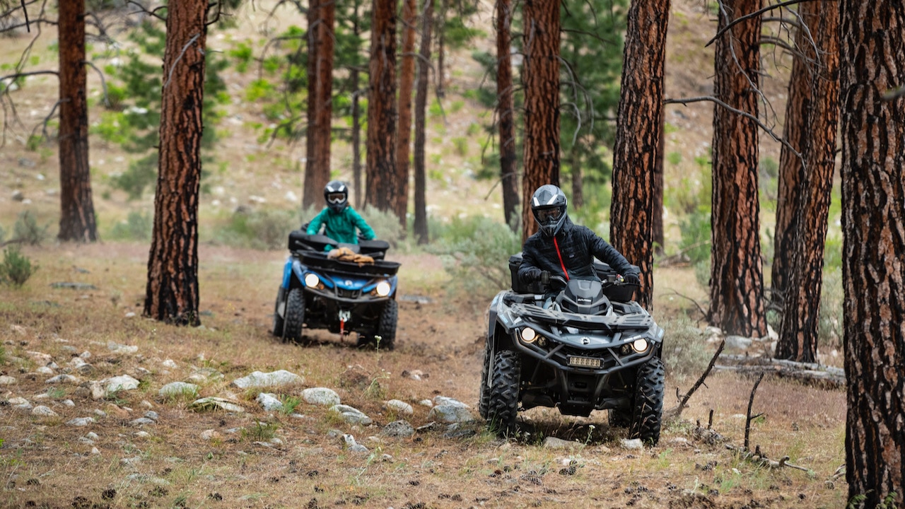 Two Can-Am Outlander's on a forrest trail